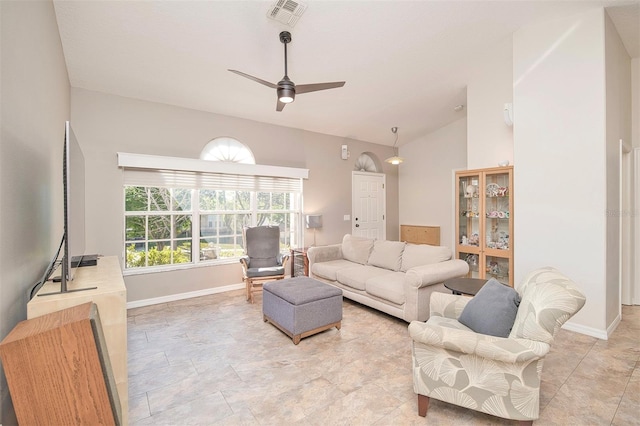 living room with lofted ceiling, baseboards, visible vents, and ceiling fan