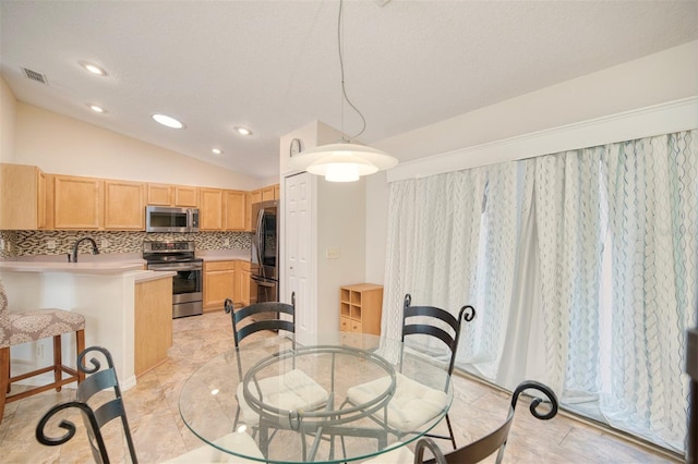 dining space with vaulted ceiling, recessed lighting, and visible vents