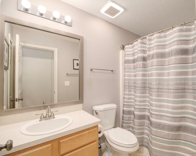 bathroom featuring vanity, a shower with curtain, visible vents, a textured ceiling, and toilet