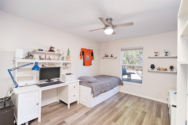 bedroom featuring baseboards, light wood-style floors, and a ceiling fan