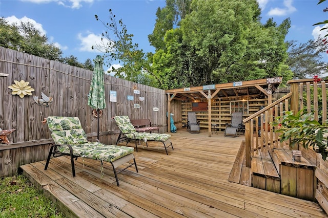 wooden terrace featuring fence