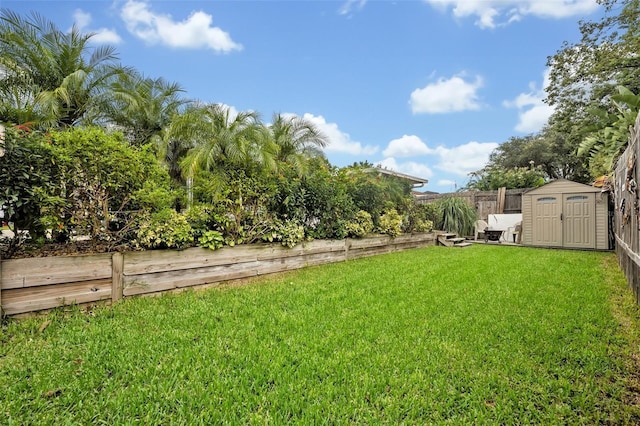 view of yard with a fenced backyard, a shed, and an outdoor structure