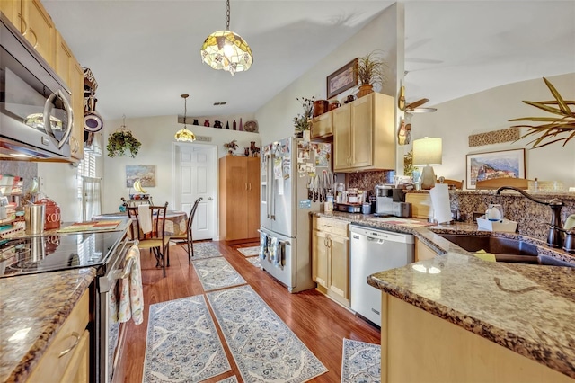 kitchen featuring light wood finished floors, a ceiling fan, appliances with stainless steel finishes, and a sink