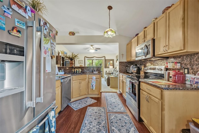 kitchen with lofted ceiling, dark wood-type flooring, appliances with stainless steel finishes, and light brown cabinetry