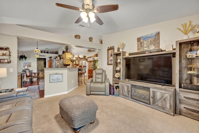 carpeted living area featuring visible vents and a ceiling fan