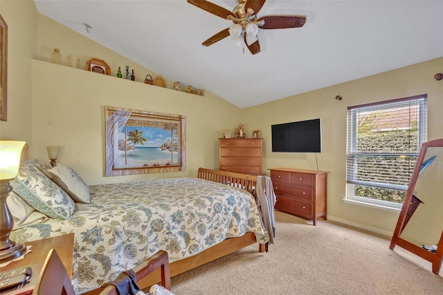 carpeted bedroom featuring lofted ceiling, baseboards, and ceiling fan