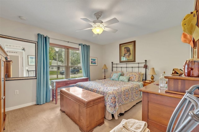 bedroom with a ceiling fan, baseboards, and light carpet