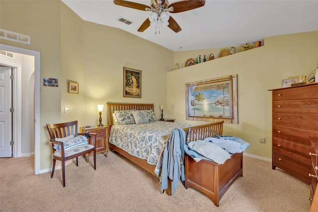 bedroom featuring vaulted ceiling, light colored carpet, and visible vents