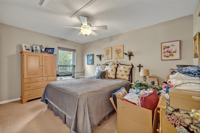 bedroom featuring a ceiling fan, baseboards, and light carpet