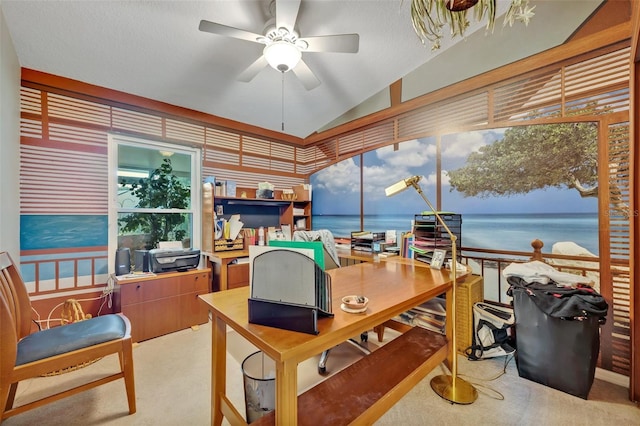 carpeted office featuring vaulted ceiling, a water view, and ceiling fan