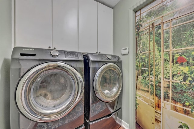 washroom featuring cabinet space and washer and dryer