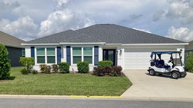 single story home featuring a front lawn, roof with shingles, concrete driveway, and an attached garage