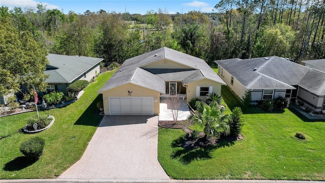 birds eye view of property featuring a view of trees