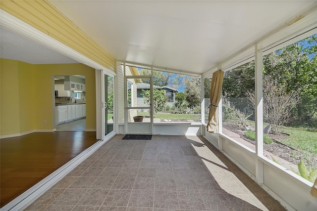 unfurnished sunroom with a sink