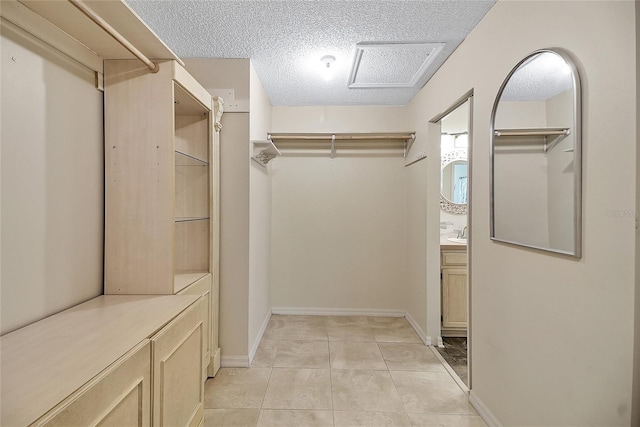 walk in closet featuring light tile patterned floors