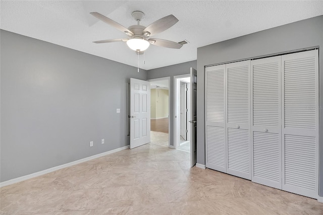 unfurnished bedroom featuring baseboards, visible vents, ceiling fan, a closet, and a textured ceiling