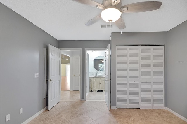 unfurnished bedroom featuring visible vents, baseboards, a closet, and a ceiling fan