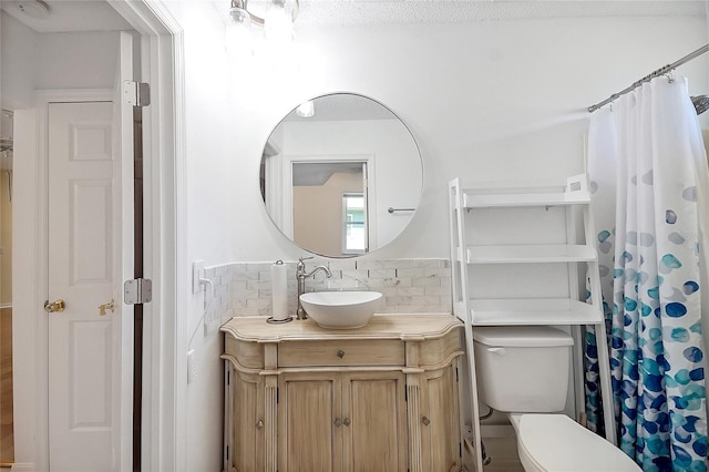 full bathroom featuring tasteful backsplash, toilet, and vanity