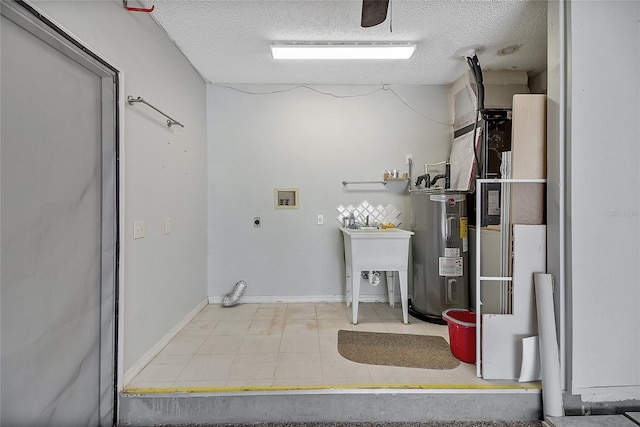 clothes washing area with electric water heater, washer hookup, laundry area, electric dryer hookup, and a textured ceiling