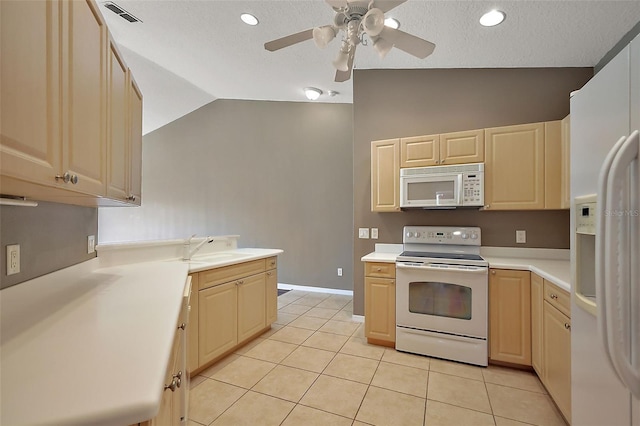 5359 Compass Pt, Oxford, FL 34484 - kitchen with visible vents, a sink, white appliances, light tile patterned flooring, and vaulted ceiling