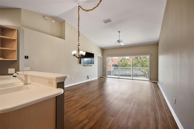 5359 Compass Pt, Oxford, FL 34484 - unfurnished living room featuring baseboards, dark wood finished floors, lofted ceiling, ceiling fan with notable chandelier, and a sink