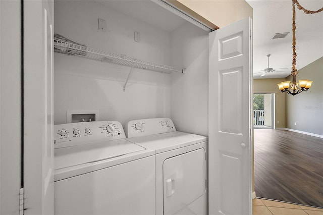 5359 Compass Pt, Oxford, FL 34484 - clothes washing area featuring light tile patterned floors, baseboards, visible vents, washing machine and clothes dryer, and laundry area