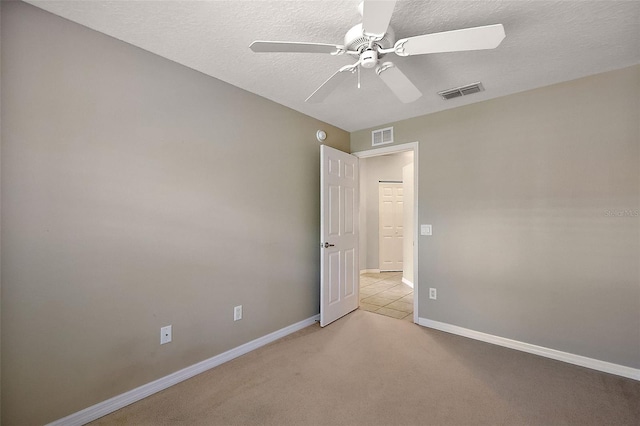5359 Compass Pt, Oxford, FL 34484 - empty room featuring a textured ceiling, light carpet, visible vents, and ceiling fan