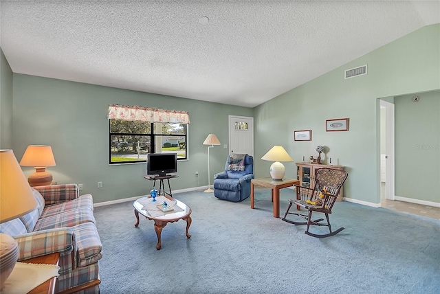 carpeted living room with vaulted ceiling, baseboards, visible vents, and a textured ceiling