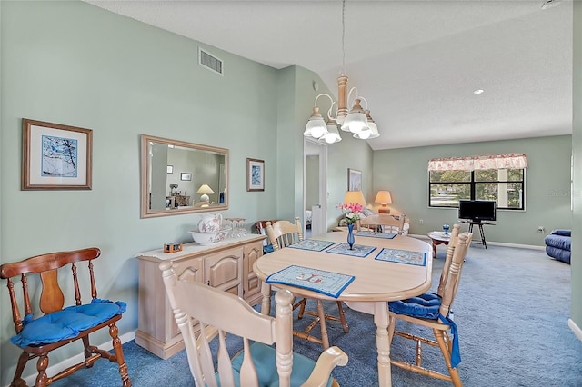 carpeted dining area with baseboards, visible vents, and a chandelier