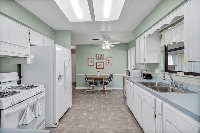 kitchen with white appliances, baseboards, visible vents, a sink, and white cabinetry