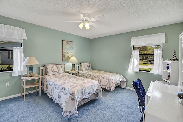 bedroom featuring a textured ceiling, carpet, baseboards, and ceiling fan