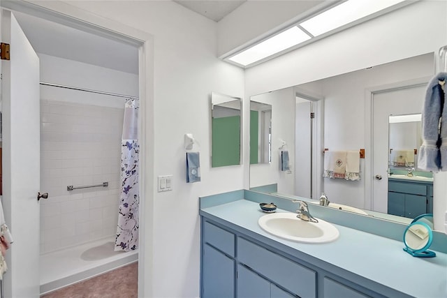 full bath with vanity and a tile shower