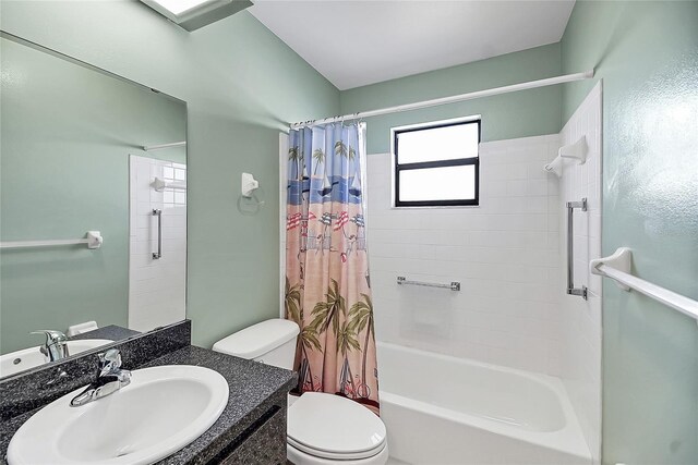 full bathroom featuring vanity, shower / bath combination with curtain, and toilet