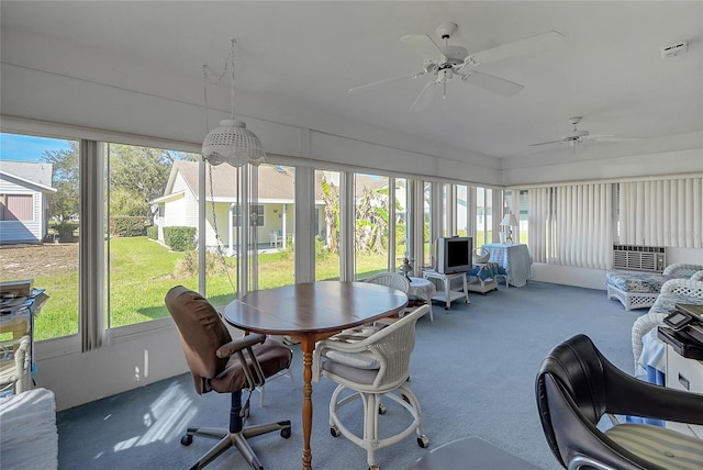 sunroom with a healthy amount of sunlight and ceiling fan