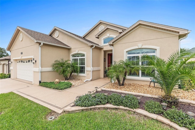 single story home with a garage, stucco siding, and concrete driveway