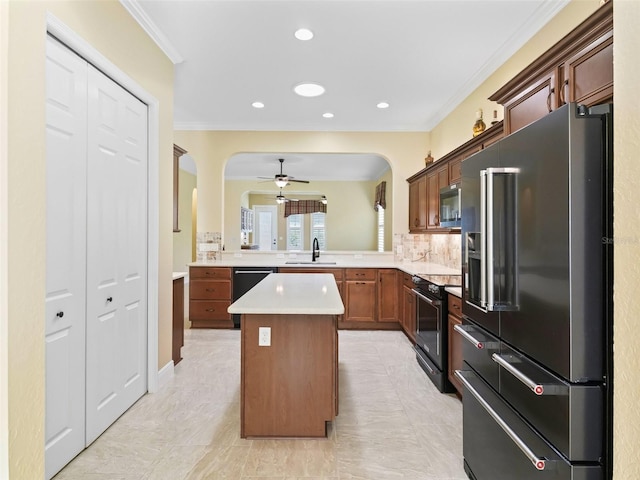 kitchen featuring arched walkways, black range with electric cooktop, a sink, stainless steel microwave, and high end refrigerator