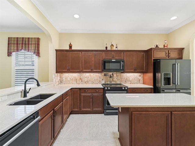 kitchen with a sink, tasteful backsplash, black appliances, and crown molding
