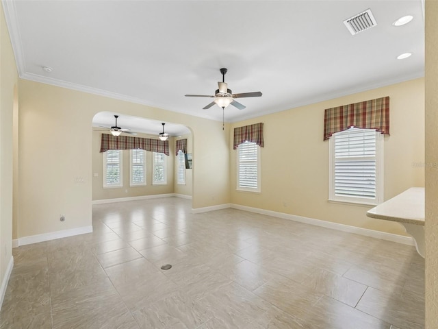 empty room with arched walkways, visible vents, a ceiling fan, and ornamental molding