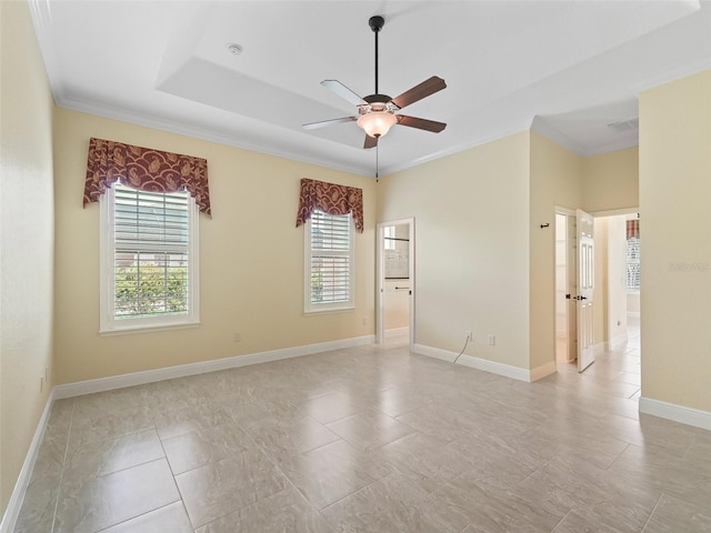 unfurnished room with ceiling fan, baseboards, and ornamental molding