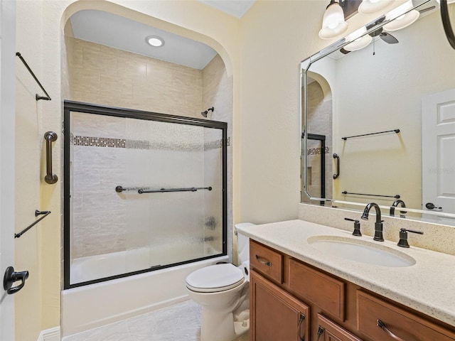 full bath with toilet, vanity, and combined bath / shower with glass door