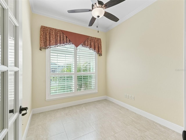 empty room with crown molding, baseboards, and ceiling fan