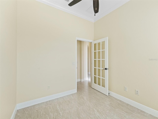 unfurnished room with baseboards, crown molding, and a ceiling fan