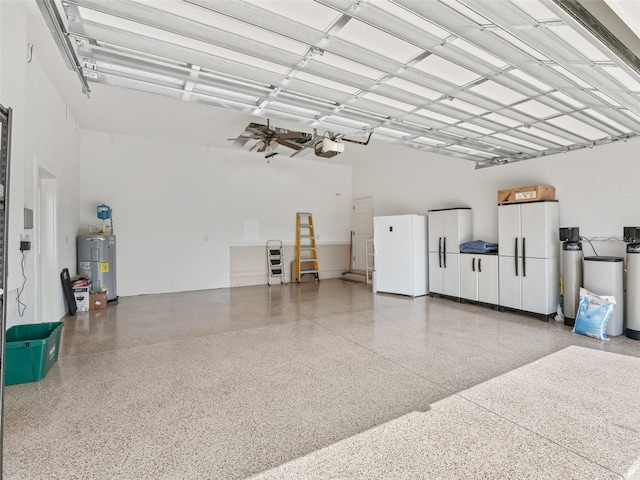 garage featuring electric water heater and a garage door opener