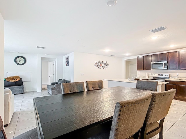 dining area featuring light tile patterned floors, visible vents, and recessed lighting