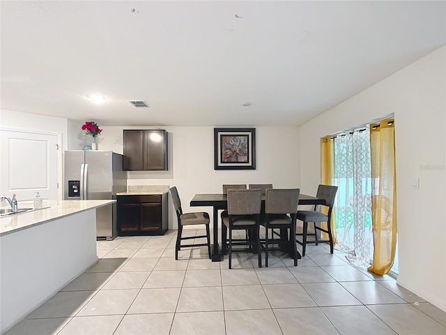 dining room with visible vents and light tile patterned flooring