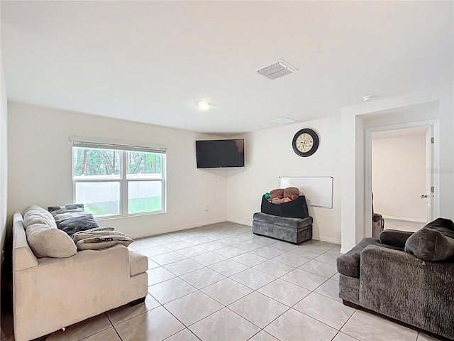 living area featuring visible vents, baseboards, and light tile patterned flooring