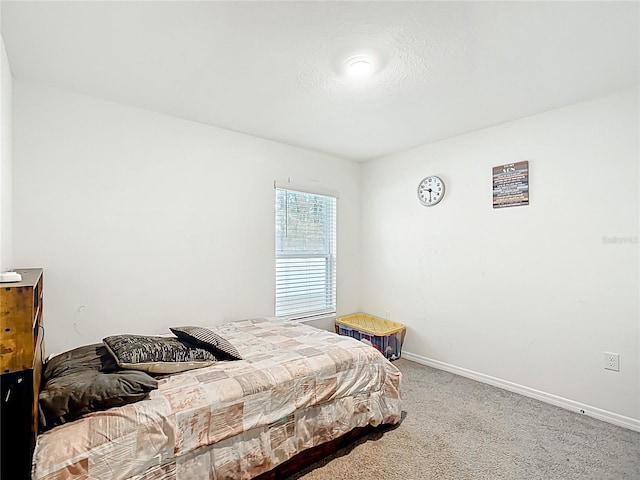 bedroom featuring carpet and baseboards