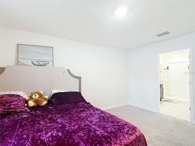 bedroom featuring ensuite bath, carpet flooring, baseboards, and visible vents