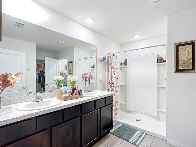 full bath with tile patterned floors, visible vents, a stall shower, and a sink