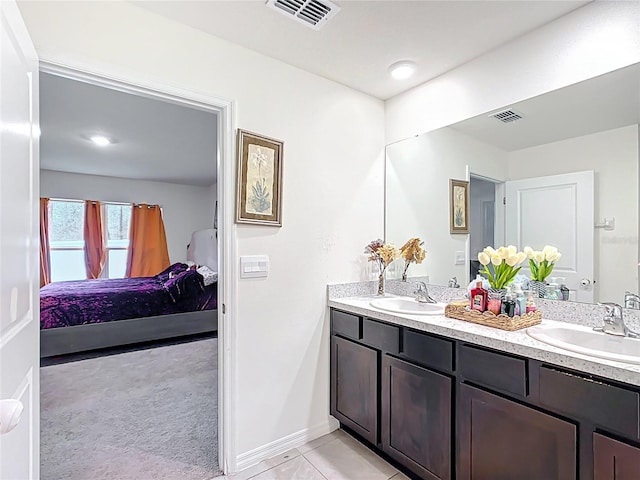 ensuite bathroom with double vanity, visible vents, ensuite bathroom, and a sink